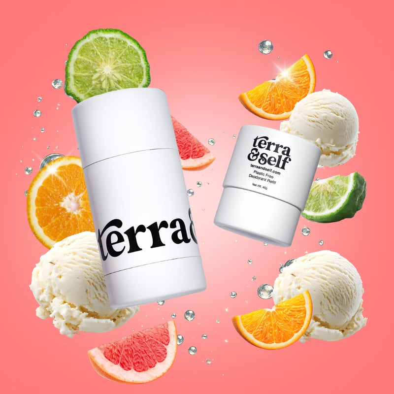 Terra & Self reusable deodorant applicator and plastic-free refill on a coral pink background, surrounded by orange slices, grapefruit wedges, lime slices, scoops of vanilla ice cream, and water droplets.