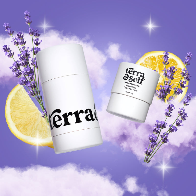 Terra & Self reusable deodorant applicator and plastic-free refill floating among soft purple clouds against a lavender sky, accented with sprigs of lavender, lemon slices, and twinkling star-shaped light flares.